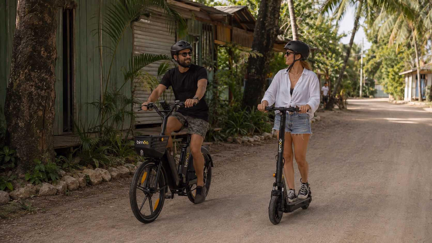 Helmeted visitors riding exact-model Bimba e-bike and scooter on a Santa Teresa itinerary