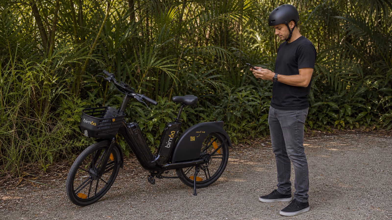 Helmeted Bimba rider stopped safely beside an e-bike before checking the app