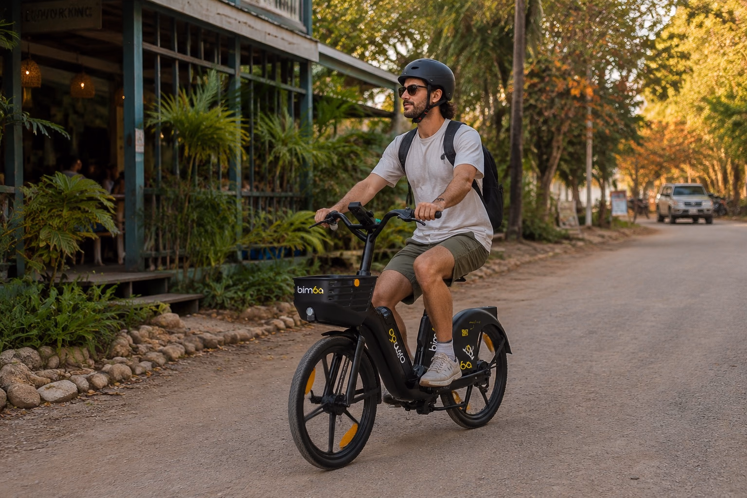 Helmeted remote worker commuting on an exact-model Bimba e-bike in Santa Teresa
