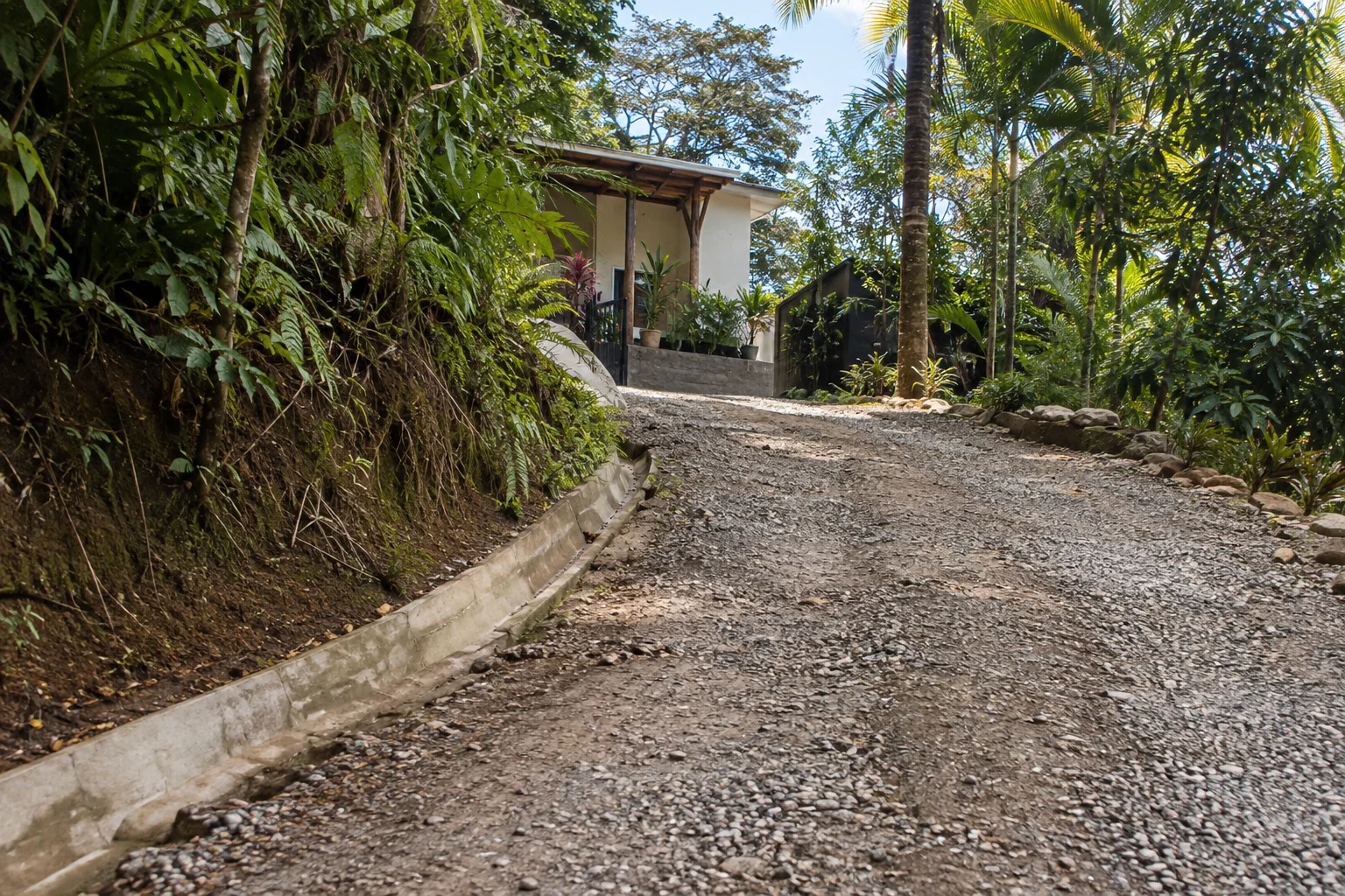 Sloped driveway leading to a hillside guesthouse