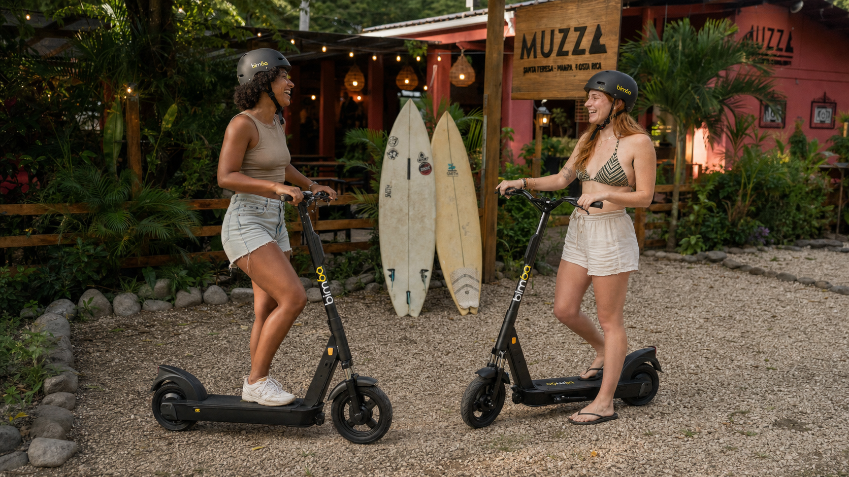 Two Bimba electric scooters with riders outside a Santa Teresa business